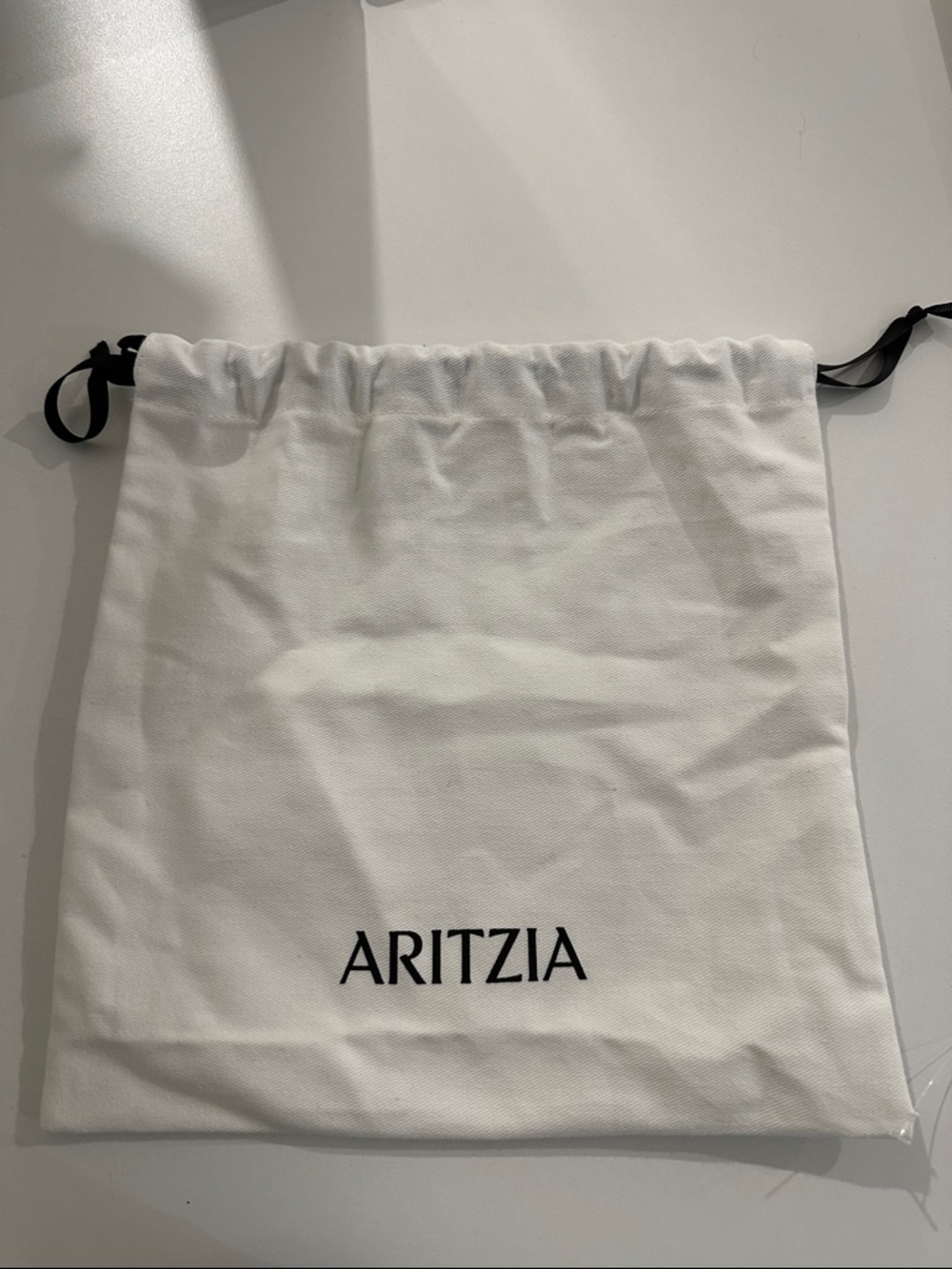Aritzia White Canvas Drawstring Bag with Black Ribbon